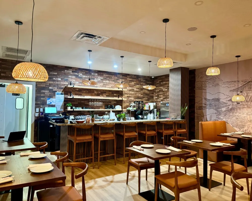 Warm bar area with brick walls and pendant lights at SOHO Asian Fusion, a Asian Fusion Restaurant in Austin.