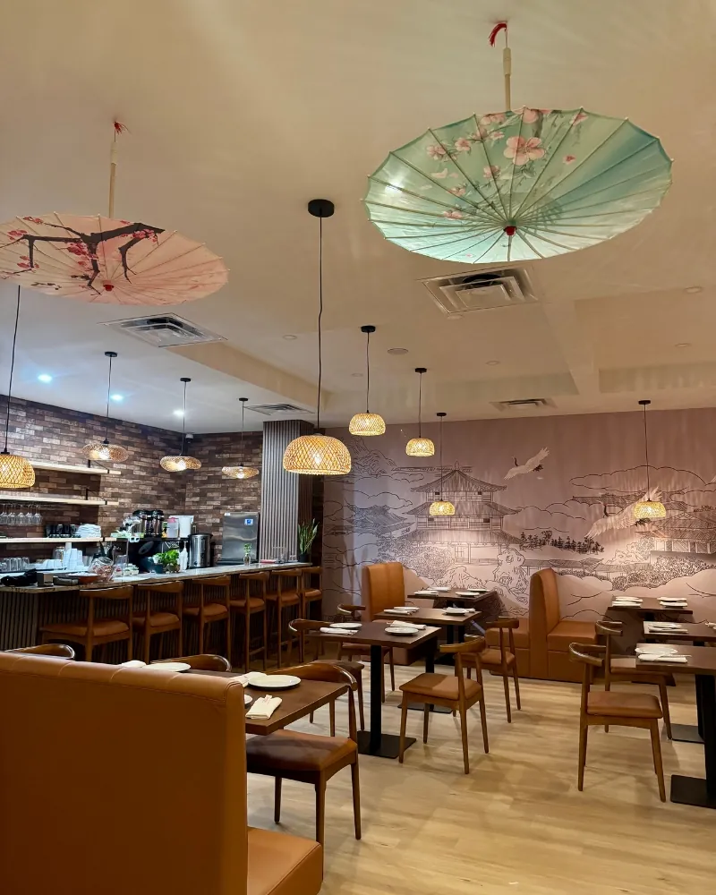 Charming dining room with paper umbrellas and Asian murals at SOHO Asian Fusion, a Asian Fusion Restaurant in Austin.