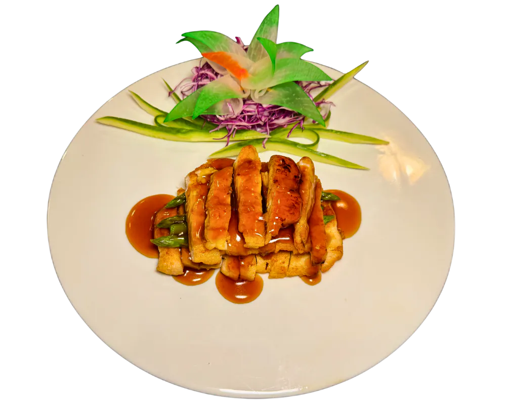 Glazed teriyaki chicken with fresh vegetable garnish at SOHO Asian Fusion, a Asian Fusion Restaurant in Austin.